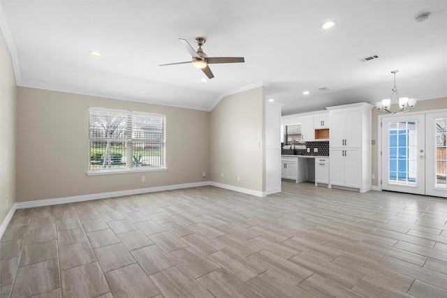 unfurnished living room featuring light wood-style flooring, plenty of natural light, french doors, and visible vents