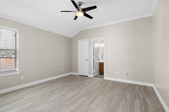 unfurnished bedroom featuring vaulted ceiling, crown molding, baseboards, and light wood finished floors