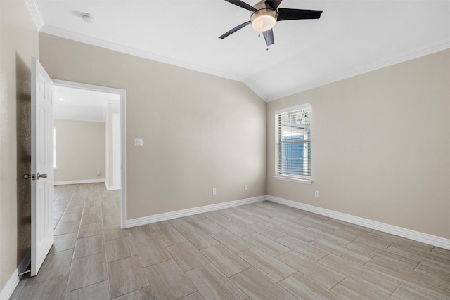 empty room with baseboards, crown molding, a ceiling fan, and vaulted ceiling