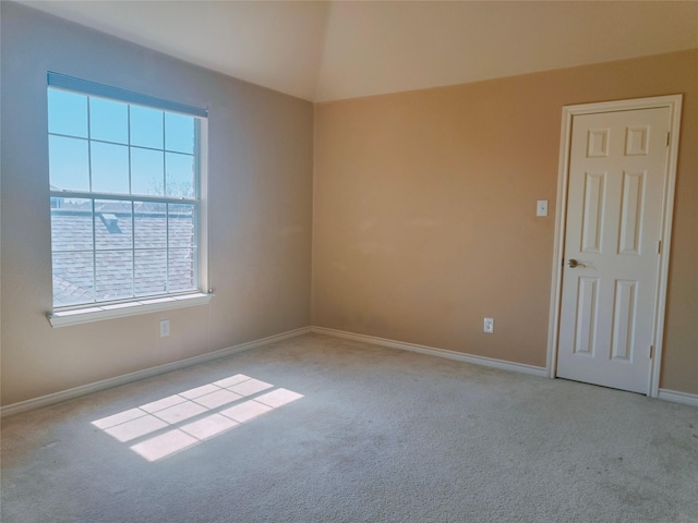 carpeted spare room with baseboards