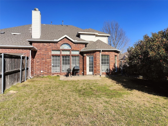 back of house with brick siding, a fenced backyard, and a shingled roof