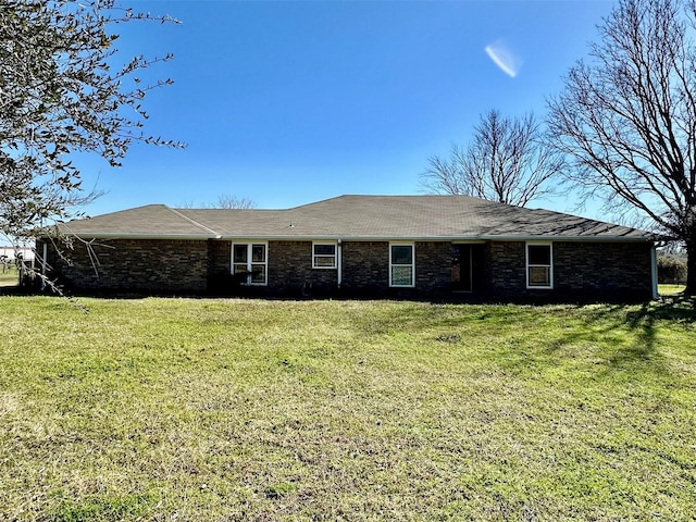 view of front of house featuring a front yard and brick siding