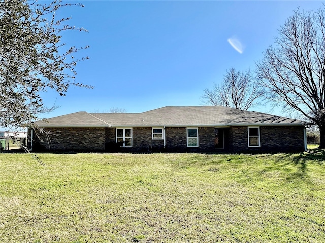 ranch-style house with brick siding and a front yard