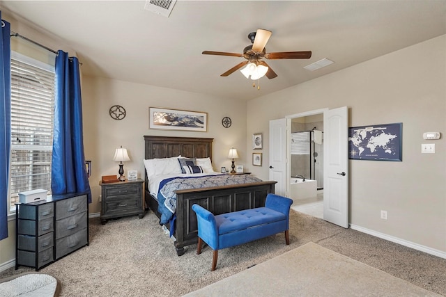 carpeted bedroom with visible vents, baseboards, ensuite bath, and a ceiling fan