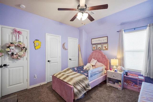 bedroom with lofted ceiling, a ceiling fan, and dark carpet