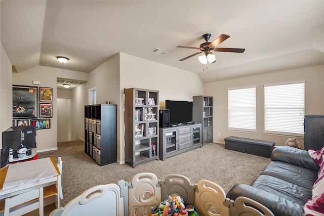 carpeted living area featuring visible vents, baseboards, a ceiling fan, and vaulted ceiling