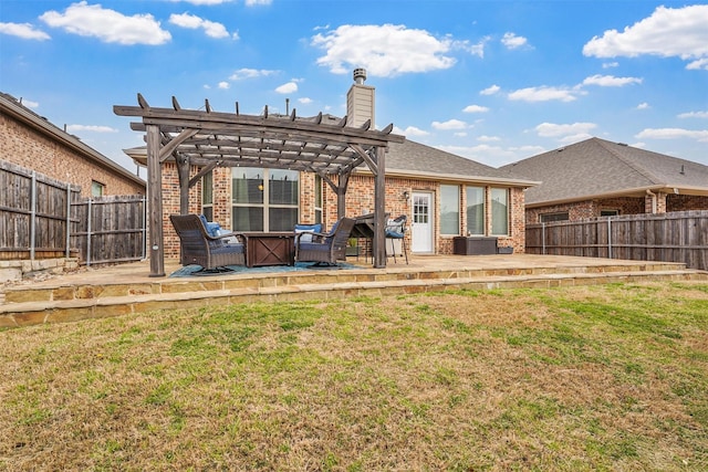 rear view of house featuring a pergola, a yard, a fenced backyard, and brick siding