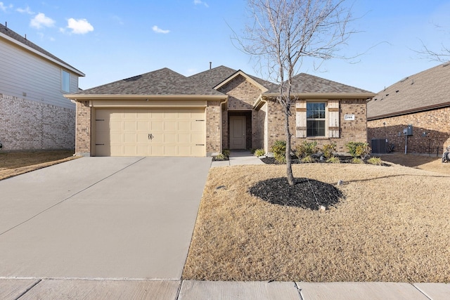 ranch-style house featuring brick siding, concrete driveway, an attached garage, and a shingled roof