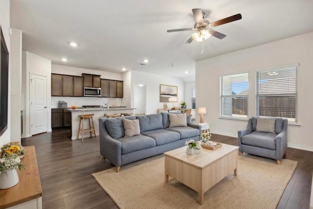 living area with dark wood-style floors, recessed lighting, a ceiling fan, and baseboards