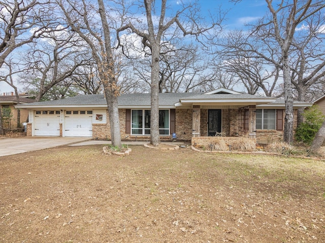 ranch-style home featuring brick siding, driveway, and a garage