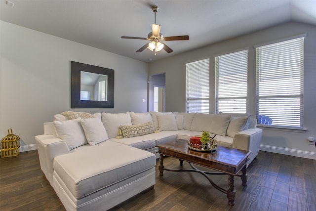 living room with ceiling fan, baseboards, and dark wood finished floors