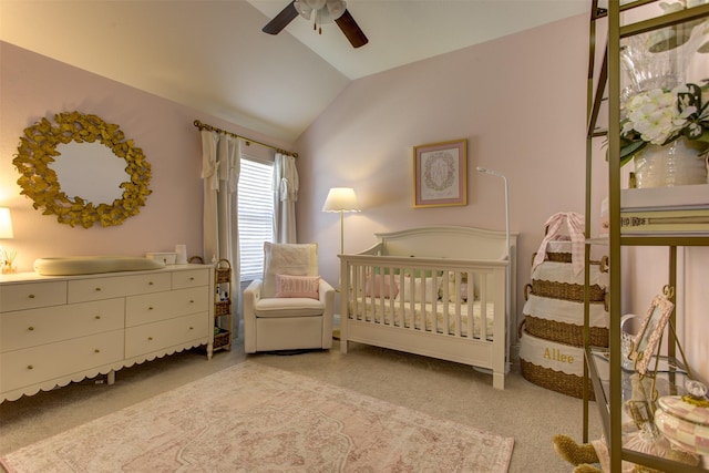 bedroom featuring carpet flooring, a crib, a ceiling fan, and vaulted ceiling