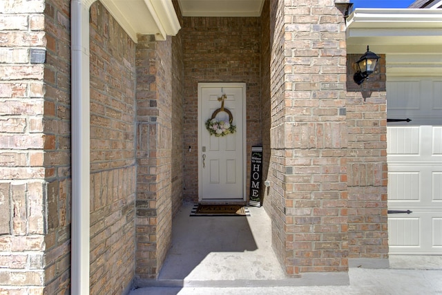 property entrance with brick siding and a garage