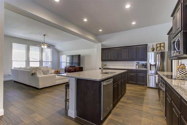 kitchen featuring backsplash, appliances with stainless steel finishes, and dark wood-style floors