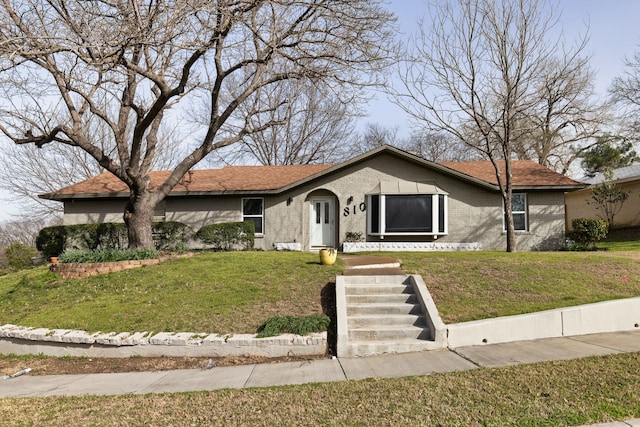 ranch-style house with a front lawn and brick siding