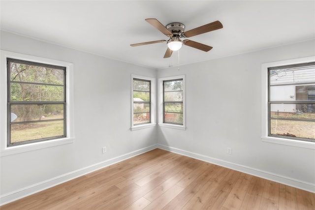 unfurnished room featuring baseboards, light wood-style floors, and ceiling fan