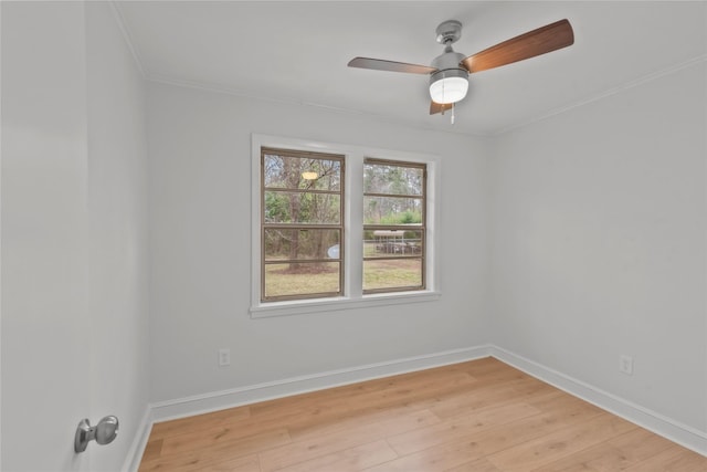 unfurnished room featuring baseboards, a ceiling fan, crown molding, and light wood finished floors