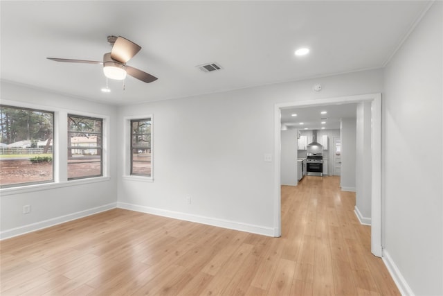 empty room featuring light wood-type flooring, visible vents, a ceiling fan, recessed lighting, and baseboards