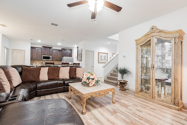 living area with stairs, recessed lighting, visible vents, and light wood finished floors