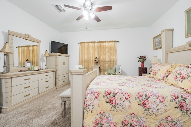 carpeted bedroom with visible vents and ceiling fan