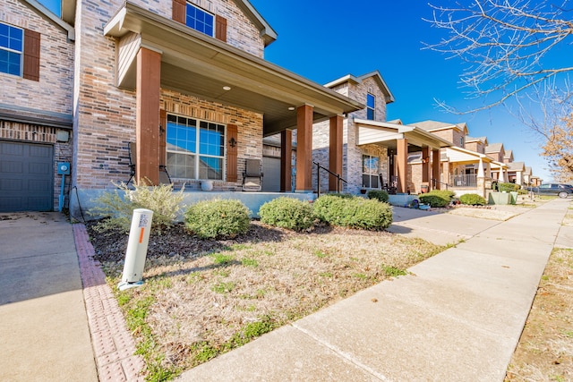 view of front of property featuring brick siding, covered porch, and a residential view