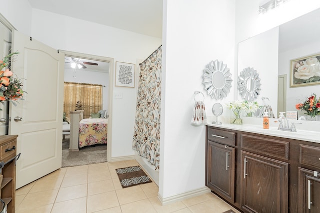 bathroom with tile patterned flooring, a shower with shower curtain, vanity, and ceiling fan