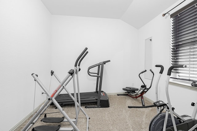 exercise area with baseboards and lofted ceiling