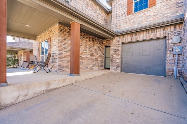 exterior space with brick siding, concrete driveway, and an attached garage