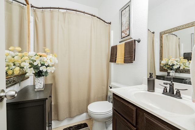 bathroom featuring toilet and vanity