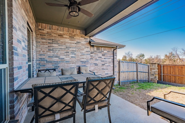 view of patio / terrace featuring outdoor dining area, a fenced backyard, and a ceiling fan