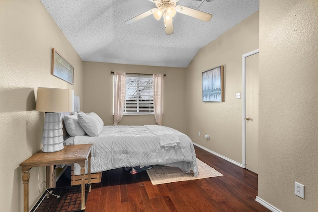 bedroom featuring lofted ceiling, a ceiling fan, a textured ceiling, wood finished floors, and baseboards