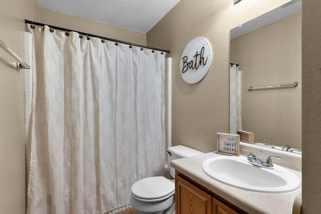 full bath with vanity, toilet, a textured wall, and a textured ceiling