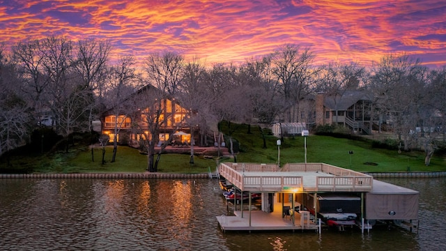 dock area with stairway, a lawn, a water view, and boat lift