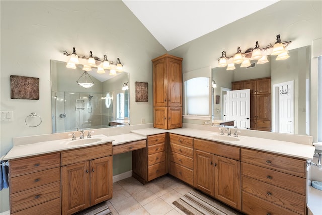 bathroom featuring tile patterned flooring, a stall shower, vanity, and vaulted ceiling