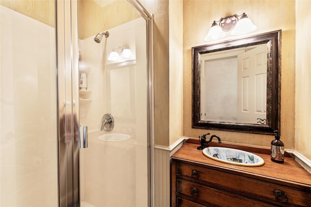 full bath with a stall shower and vanity