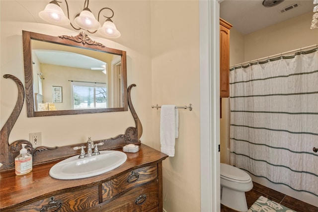 full bath featuring vanity, a shower with curtain, visible vents, tile patterned flooring, and toilet