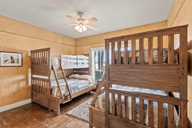 bedroom featuring baseboards and ceiling fan