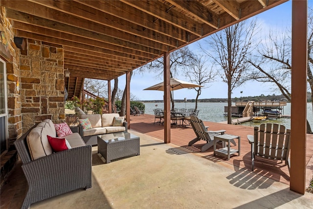 view of patio / terrace featuring a boat dock, a water view, and an outdoor hangout area