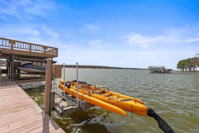 view of dock with boat lift and a water view