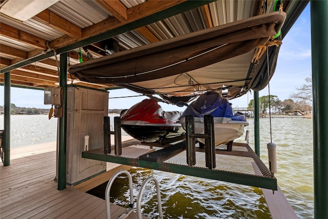 dock area featuring boat lift and a water view