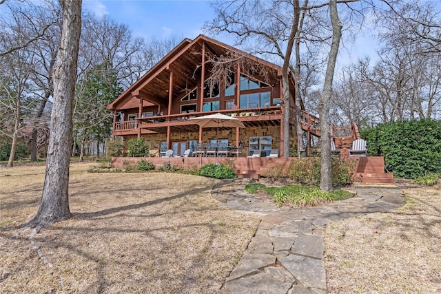 rear view of property with stone siding