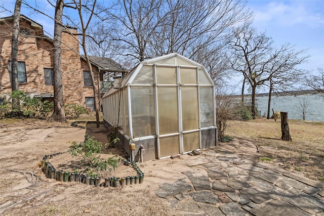 view of greenhouse featuring a water view