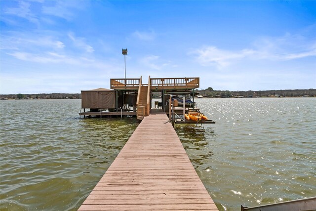 view of dock featuring boat lift and a water view