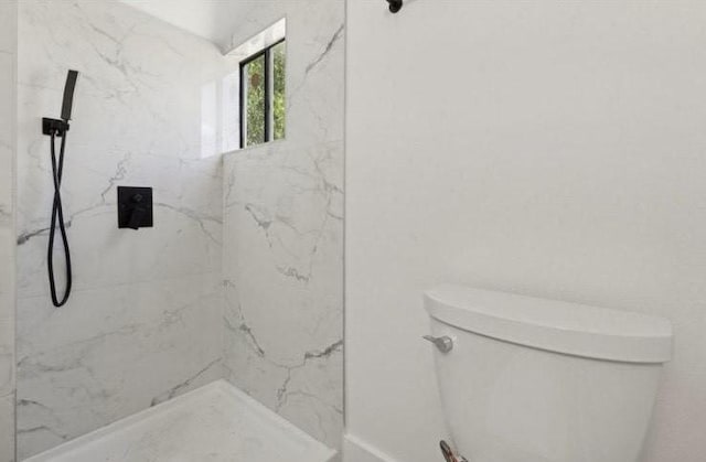 bathroom with a marble finish shower