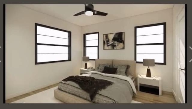 bedroom featuring baseboards, wood finished floors, and a ceiling fan