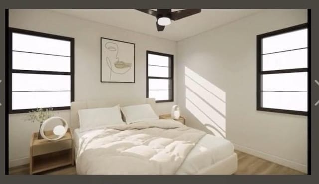 bedroom featuring ceiling fan, baseboards, and wood finished floors