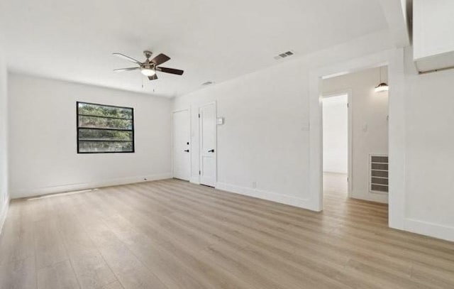 unfurnished room with visible vents, baseboards, and light wood-style floors