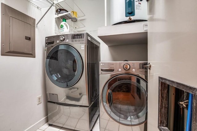 washroom with washing machine and clothes dryer, baseboards, electric panel, laundry area, and light tile patterned flooring