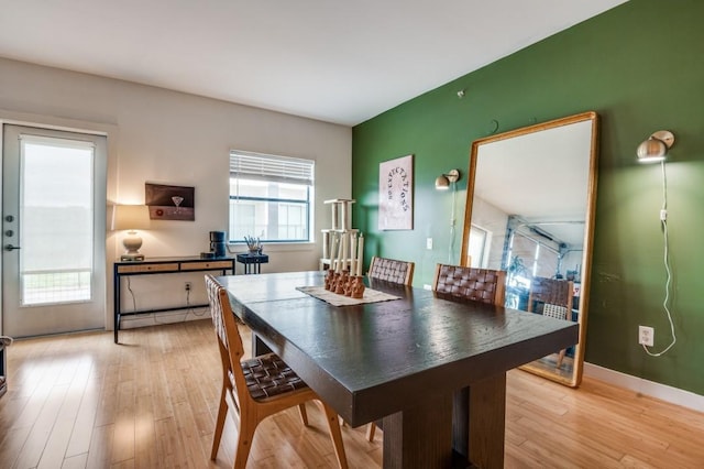 dining room featuring plenty of natural light, light wood-style floors, and baseboards