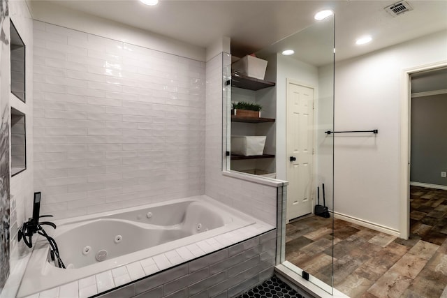 1809 Faulkner Dr, Rowlett, TX 75088 - bathroom featuring recessed lighting, baseboards, a tub with jets, wood finished floors, and visible vents